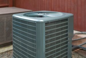 Outdoor residential air conditioner serviced for routine AC maintenance, showing a clean and functioning HVAC unit—ideal for understanding what an AC tune up includes, such as coil cleaning, refrigerant checks, and system inspection by Family Heating and Cooling. Call today for help with AC tune up checklist, what’s included in an AC tune up, air conditioner maintenance service, AC inspection near me, HVAC tune up services, seasonal AC maintenance, air conditioning service near me, air conditioner tune up near me, home AC maintenance, central air conditioner service, HVAC maintenance near me, AC system check up, professional AC cleaning, condenser coil cleaning, refrigerant level check, thermostat inspection, air filter replacement, blower motor inspection, residential AC services, annual AC maintenance plan, HVAC system tune up near me, air conditioning maintenance in New Bedford, Fall River AC services, Taunton HVAC contractors, Somerset air conditioner repair, Dartmouth HVAC tune up, Fairhaven AC maintenance.