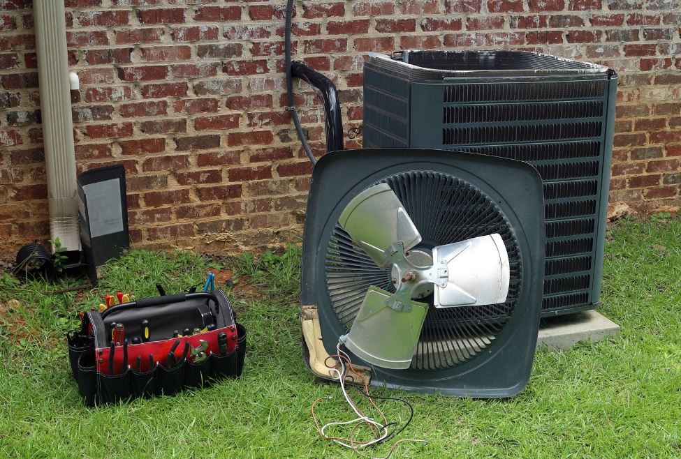 HVAC technician repairing outdoor AC unit to fix grinding noise, air conditioner making grinding sound, AC repair services, noisy air conditioner diagnosis, Family Heating and Cooling AC troubleshooting. Trust us to help with why is my air conditioner making a grinding sound, AC making grinding noise, air conditioner noise troubleshooting, grinding noise from AC unit, loud AC unit sounds, AC compressor grinding sound, HVAC noise issues, air conditioning repair near me, AC service near me, HVAC repair near me, AC unit making noise when running, fix noisy air conditioner, air conditioner making loud noise outside, HVAC technician near me, air conditioner motor noise, AC fan grinding, home AC noise repair, emergency AC repair near me, air conditioning maintenance services, Family Heating and Cooling air conditioner repair, residential HVAC services, air conditioner inspection near me.