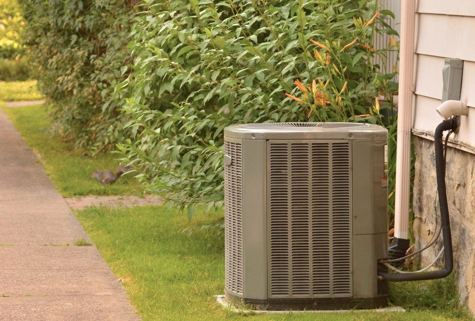 Outdoor air conditioning unit at a residential building, representing common HVAC emergencies such as no cooling, AC breakdowns, or refrigerant leaks; Family Heating and Cooling offers emergency AC repair, HVAC service, and air conditioning repair for sudden system failures. Reach out today for help with what qualifies as an HVAC emergency, HVAC emergency services, emergency HVAC repair, 24 hour HVAC repair near me, emergency air conditioning repair, emergency furnace repair, no heat emergency repair, air conditioner not working emergency, heater stopped working suddenly, HVAC repair near me, HVAC troubleshooting emergency, urgent AC repair, furnace emergency services, air conditioning repair near me, HVAC technician near me, local HVAC company, emergency heating and cooling services, AC not cooling emergency, sudden HVAC failure, HVAC maintenance near me, heating repair near me, AC repair near me.