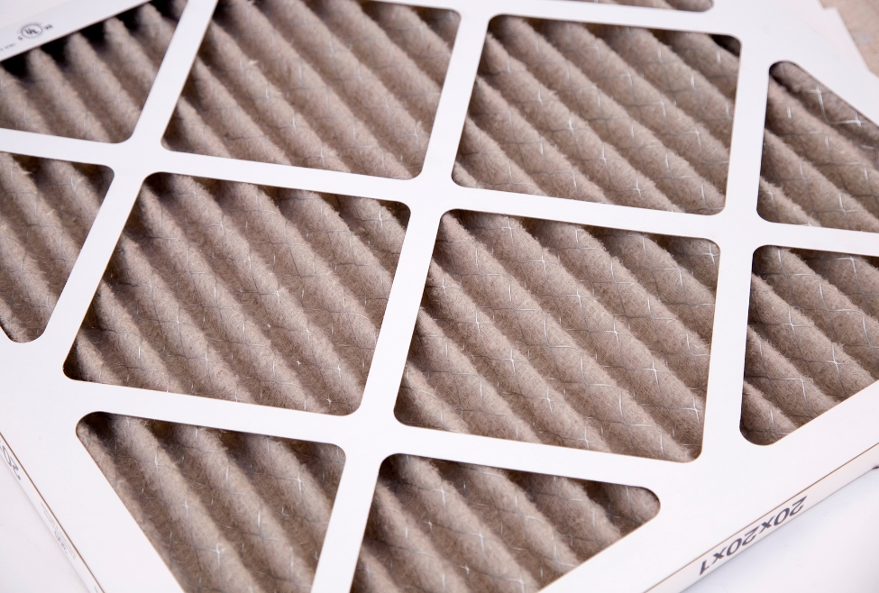 Dirty air conditioner filter, representing common issues like musty AC smell, mold in air vents, burning odor from air conditioner, and need for AC maintenance, duct cleaning, or HVAC repair by Family Heating and Cooling. Trust us today to help you with why does my AC smell, bad smell from air conditioner, musty smell from air vents, air conditioner smells like mildew, AC smells like mold, burning smell from AC unit, foul odor from HVAC system, air conditioner smells bad when turned on, AC vent smells musty, weird smell from air conditioner, AC smells like dirty socks, air conditioner odor removal, air conditioning smells musty near me, HVAC system smells bad, AC maintenance near me, HVAC inspection near me, air duct cleaning near me, air conditioner tune-up near me, HVAC repair near me, professional AC cleaning service, remove odor from air conditioner, smelly air vents in house, HVAC services for smelly AC, Family Heating and Cooling HVAC services.