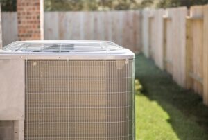 Residential air conditioner blowing hot air, possibly due to low refrigerant, dirty air filter, or faulty thermostat — common AC repair issues handled by Family Heating and Cooling's HVAC technicians. Trust us to help you with ac blowing hot air, AC not cooling, air conditioner blowing warm air, central air blowing hot air, HVAC blowing hot air, why is my AC not cold, AC repair near me, emergency AC service, air conditioning troubleshooting, home AC blowing warm air, AC blowing hot air fix, low refrigerant symptoms, AC recharge service, thermostat problems AC, air filter clogged AC, AC unit blowing hot air in house, air conditioning repair near me, HVAC repair near me, AC service near me, air conditioning maintenance, Family Heating and Cooling AC services, AC compressor problems, broken air conditioner repair.