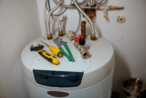 Water heater showing potential low hot water pressure issues caused by sediment buildup, clogged plumbing lines, or internal tank restriction, indicating need for water heater repair, plumbing inspection, and hot water pressure troubleshooting by Family Heating, Cooling, Electric and Plumbing. Reach out to us now for help with low hot water pressure, weak hot water flow, hot water pressure low in shower, no pressure in hot water but cold is fine, uneven hot water pressure, hot water barely coming out, sudden drop in hot water pressure, water heater causing low pressure, sediment buildup water heater pressure issues, clogged hot water pipes, corroded plumbing causing low pressure, low water pressure in shower only hot, low hot water pressure kitchen sink, whole house low hot water flow, hot water pressure troubleshooting, plumbing repair for low water pressure, water heater maintenance near me, water heater repair near me, hot water pressure repair near me, plumber near me for low water pressure, emergency plumbing service near me, residential plumbing services near me, water heater flush service near me, pipe corrosion repair plumbing near me, hot water system inspection near me, Family Heating Cooling Electric and Plumbing plumbing services, water heater diagnostics near me, hot water flow restoration service, clogged water line repair near me, home plumbing inspection low pressure issues.