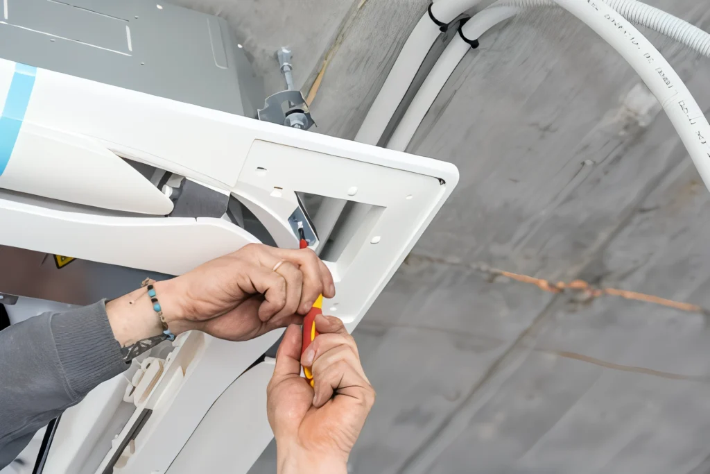 Technician installing a mini split air conditioning unit.