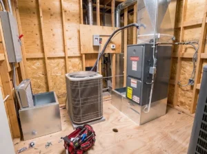 HVAC system installation with air conditioner and furnace in a wooden utility room.