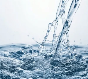 Water splashing into a pool, creating bubbles and ripples.